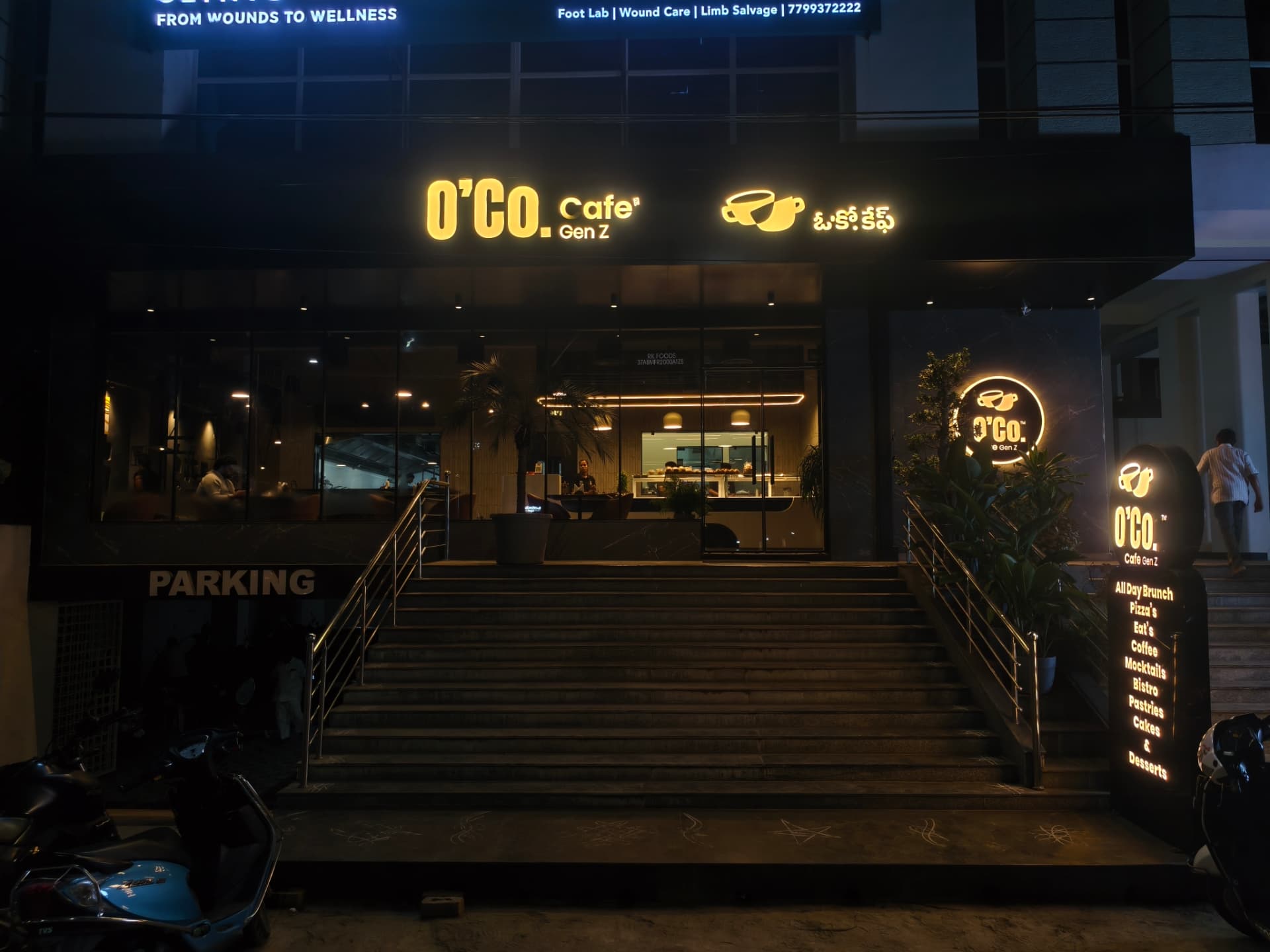 The illuminated O’Co Cafe Gen Z storefront at night